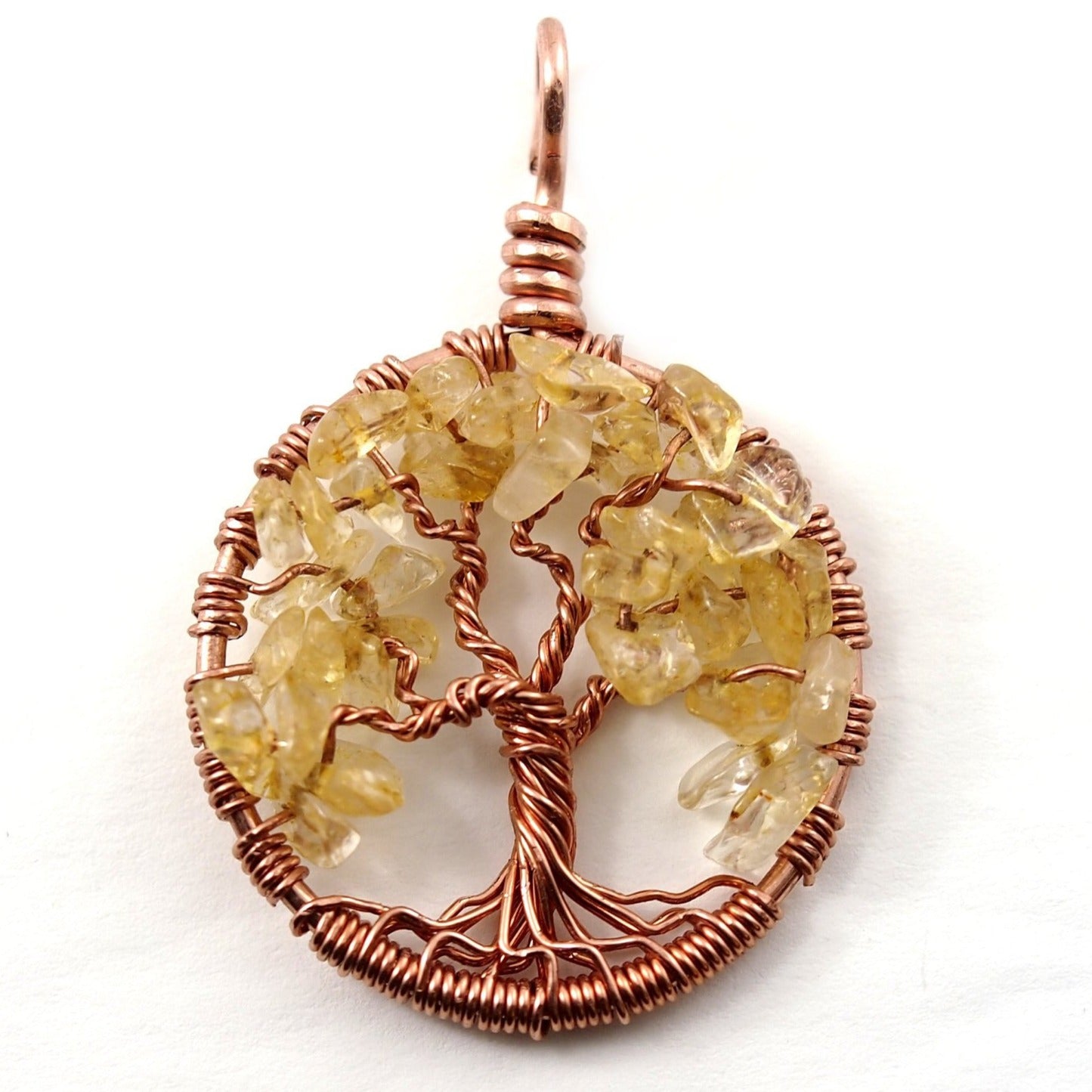 A close up image of the November birthstone tree of life pendant from Uncorked & Bottled Up made with genuine citrine gemstones and copper wire